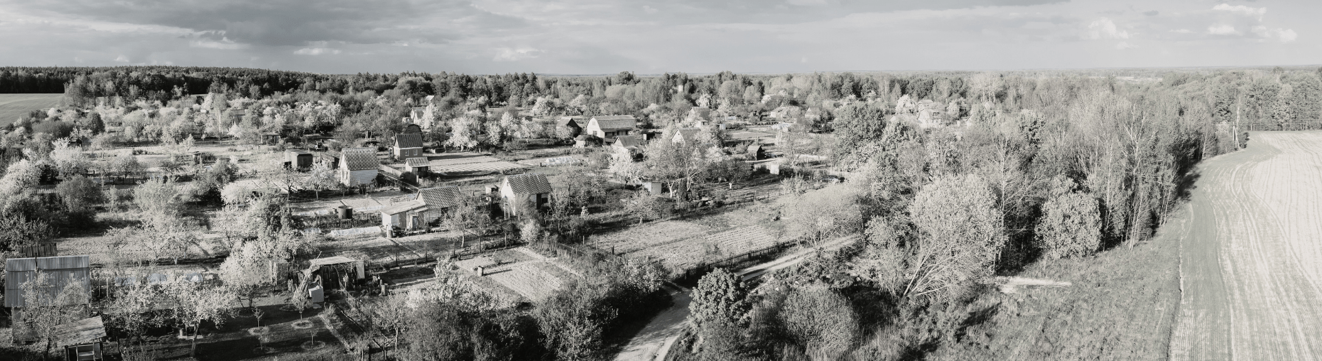 Small Town from Above Aerial view of a quaint town, showcasing homes and greenery from an elevated perspective.