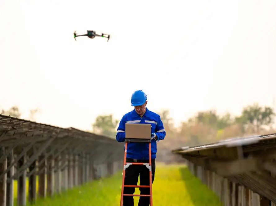 Drone operator conducting an inspection of solar panels, ensuring efficient energy use.