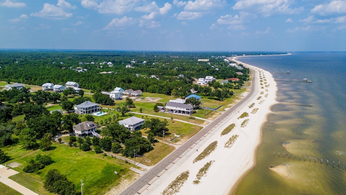 A serene aerial view of the beach in Waveland, MS—showcasing why video tours can make your listings sell faster by zooming in to highlight just how close the beach is and its inviting charm.